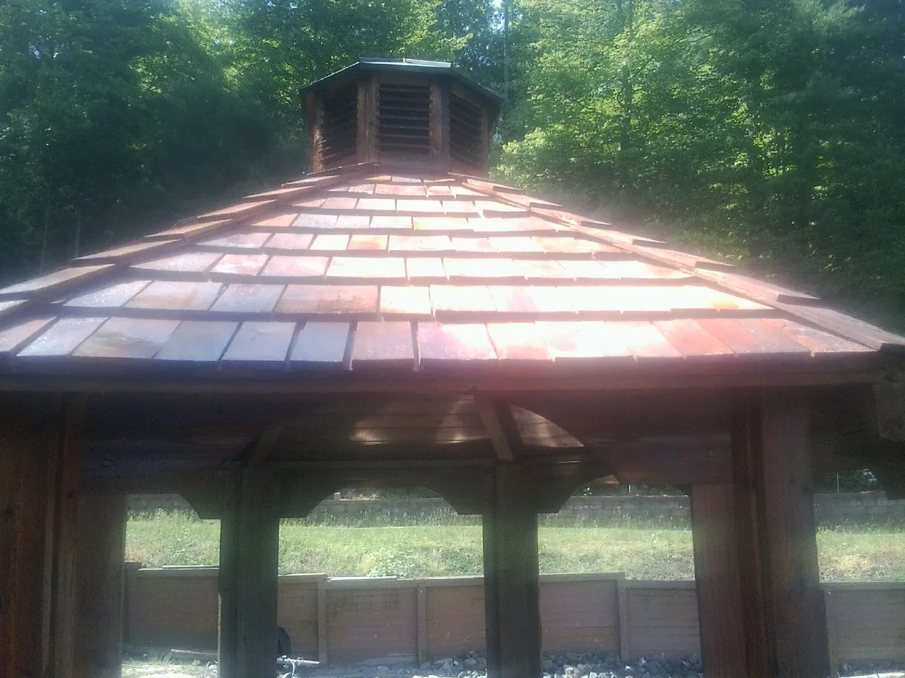 New cedar shake roof and cupola on a lakeside gazebo in West Milton