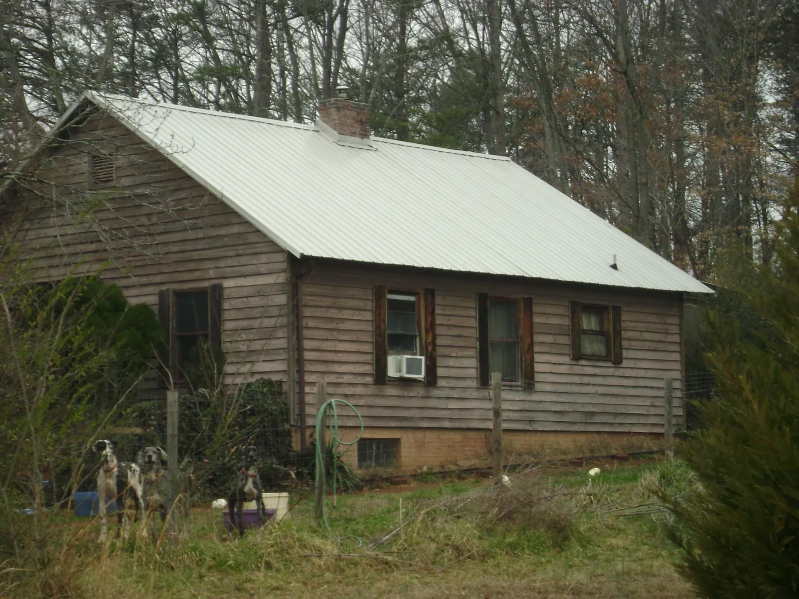 White metal roof on an old wood sided farmhouse, from a Metal Roof Installation job in West Milton